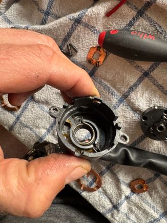 This is the spring that you press against when cranking.