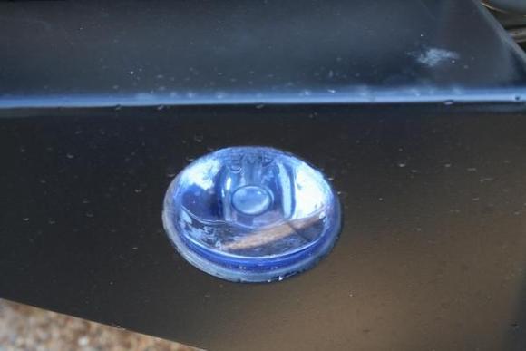 Close-up of foglight.  Looks like it is just siliconed into place. If I were doing it myself, I would have fastened it differently, but I didn't so...