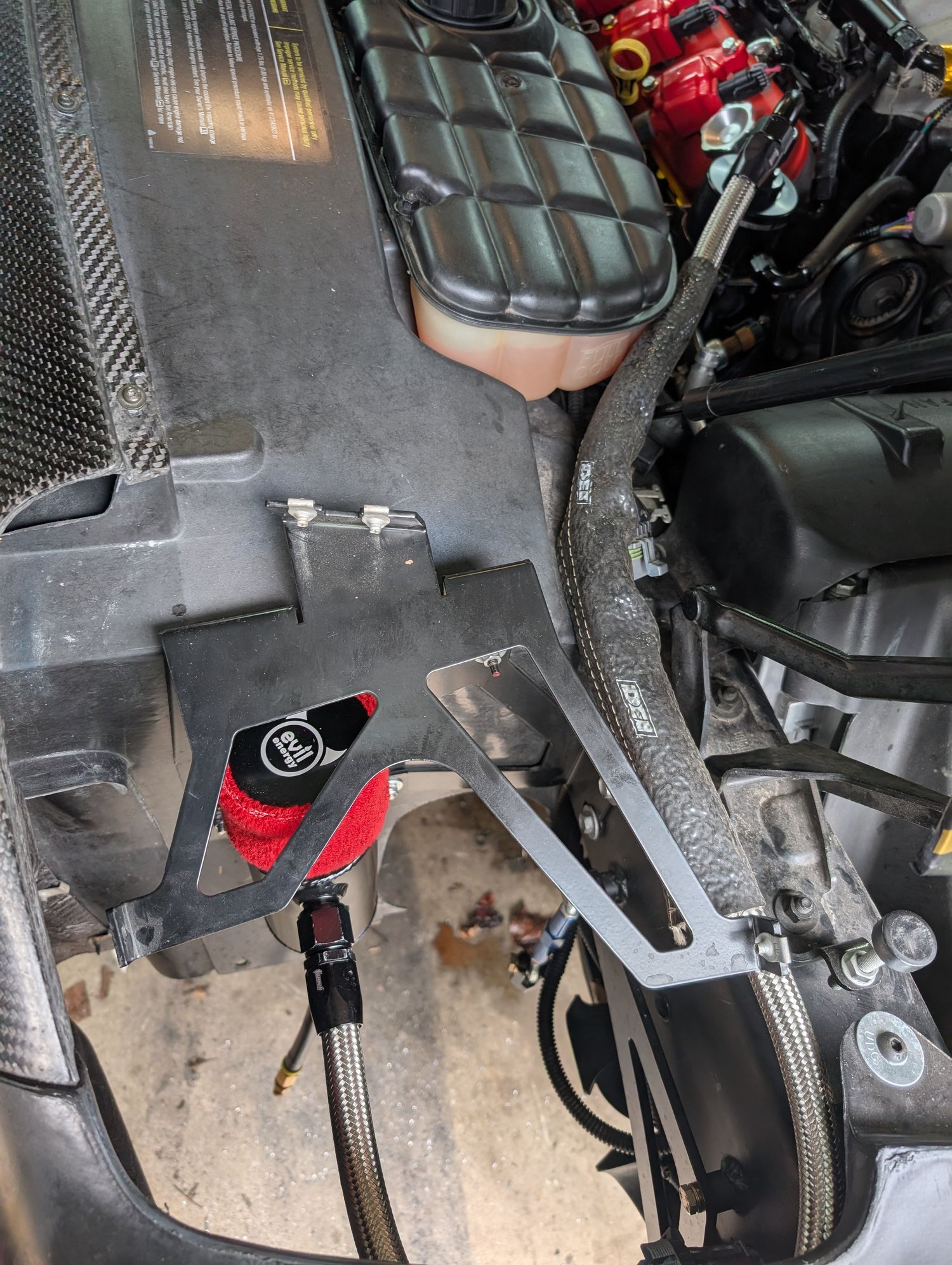 If you follow the -10 hose it goes from the can under the headlight area back to the pass side head.