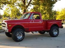 '69 Chevy pickup, big block, big lift, big tire, big axle.