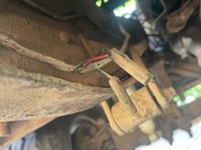 Running up the frame rail next to the transmission I found this wire connector with a red wire w/black tracer, a black wire, and a green wire w/ white tracer. 