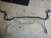 The Whiteline rear bar can't be directly compared to the OEM one, because they operate completely differently.  Still, you can see that the Whiteline unit is slightly thicker.