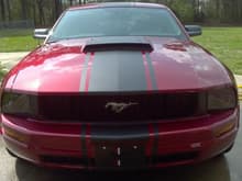 Aftermarket hood after someone decided to hit me head on.  Not sure who makes it but I've only seen a few like it.  

Blacked out front pillars, halo head lights, tag, JLT cold air kit, Bama tune.  All from American muscle other than vinyl.