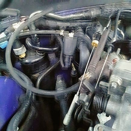 The cylinder with white T connecror on top n wires from bottom, where does the vacuum hose going to right side of picture go to? 