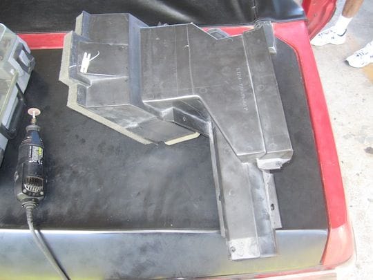Another picture of the air box that I had to modify.  Once the frame is bolted in I will build a modification to where I trimmed the air box thus allowing it to push air to the dash vents and also the windshield vents. More to folllow on this topic later.