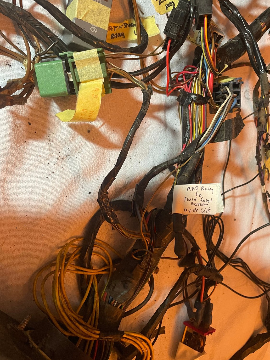 ABS warning relay on left (green).  The brown/green wire comes from pin 87, goes through diode (black rubber tube with white tape attached) and then goes off to brake fluid level switch.   This wiring isn�t shown on diagram I have