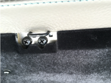ABOVE - front side of the glovebox latch.  The left screw holds the whole shebang to the glovebox, while the right screw secures a metallic triangle piece in place which jams the black U-latch into position.  The mechanism is more clear from the back side.