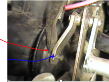 How do i separate the arm from the motor screw (see Red arrow). 
The blue arrow arm simply pulled away once the circlips were removed
