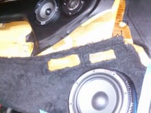 Woofer being fitted to door panel with customized speaker pod