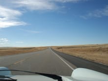 The fender view down the open road.