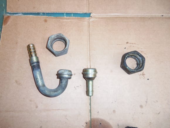 Radiator cooler hose fittings. Upper J fitting at left, lower straight fitting at right.