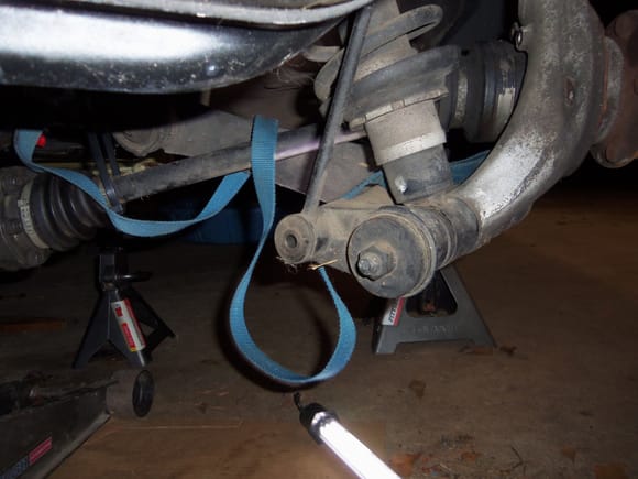 Free end of axle secured with zip ties to suspension cradle.