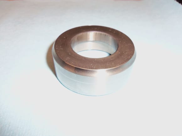 Top side of sealing cap. Edge is tapered to smoothly go through radial seals.