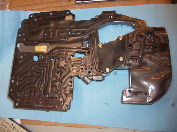 Separator plate and lower cover flipped over. Note the lower cover is still bolted to the separator plate. See the odd shaped plate and 4 yellow cad bolt heads in the approximate middle of the gasket.