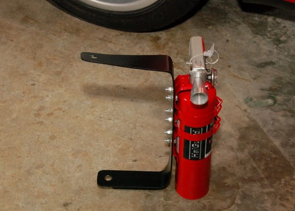 Fabricated 6061-T6 aluminum bracket for extinguisher holding harness.