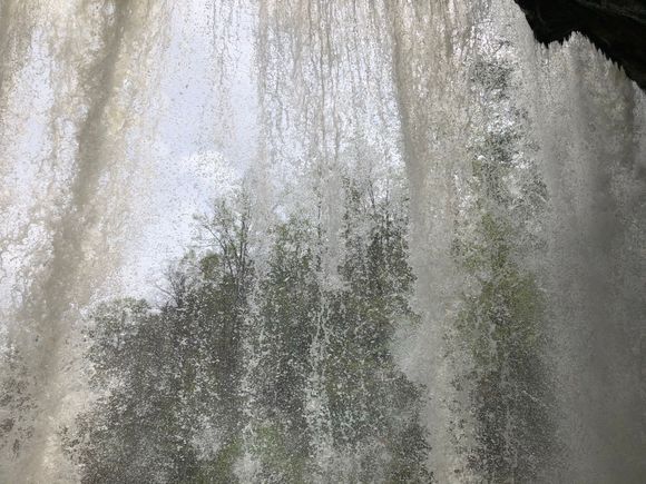 Behind the falls.