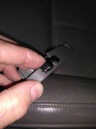 The black clip locks the hood release handle to its swivel. Use the small screw driver