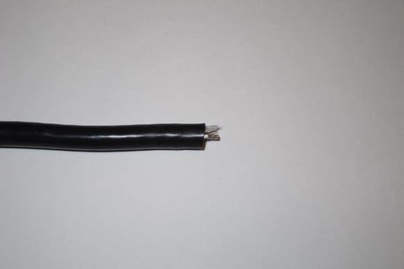 An aftermarket cable that was given to me for repair. The person that made this did not cut the insulation square and cut the wire far too short. It was less than 4 mm long and needs to be 6.8 mm long as per specification.