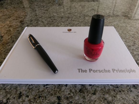 Gifts from Porsche for my wife. A nice book, a Macan pen, and "Guards Red" nail polish.