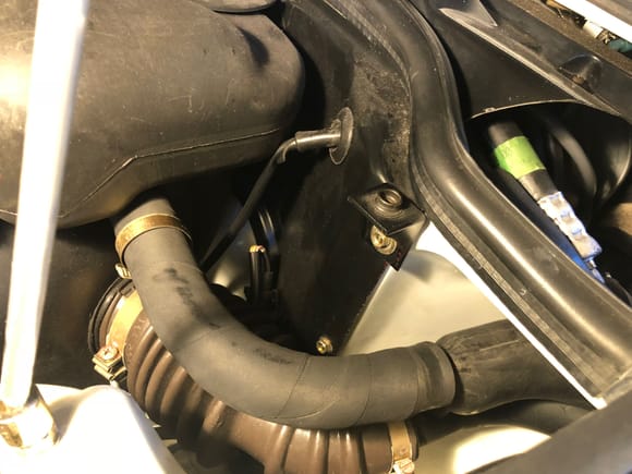 Disconnect both hoses to tank at left fender by twisting
