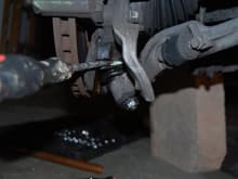 I used a pry bar to get the ball joint loose.  Here I have a screw driver in the gap.