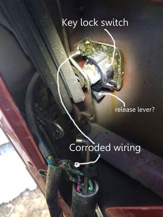 This is the key lock switch.  Half of the wires in the switch harness go to the door lock plunger switch (hanging upside down at bottom of photo) and this switch attached to the key lock on the door.  I can't figure out how to release the black plastic attachment so I can remove the entire switch harness.  Is that ribbed lever some kind of release mechanism?  I am very worried about forcing the plastic and breaking it.