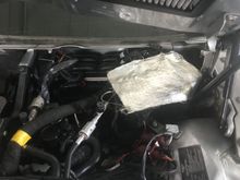 This is a piece of fireproof sheeting tie wrapped over the main fuse / relay box to protect from water .A personal mod I did .