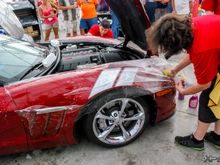 The guys from Clear Auto Bra are installing XPEL ULTIMATE on the front fenders of this Grand Sport.