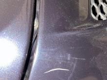 Location: driver side rear deck lid