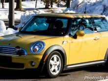 A Mini, surrounded by the tall snow berms.