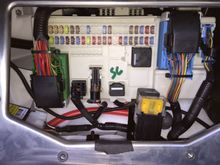 this is my fuse box, the black piece of tape at the bottom of the fuse box actually helps to secure the capacitor like piece up against the aluminum housing, it;s on thee back side.it appears to be held there by tape an velcro.