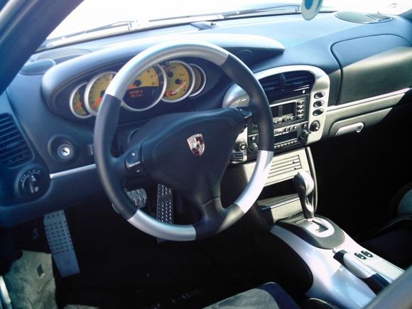 Porsche tequipment steering wheel, speed yellow gauges, aluminum gauge trim, arctic silver upper and lower center consoles, billet pedals, and dash strips