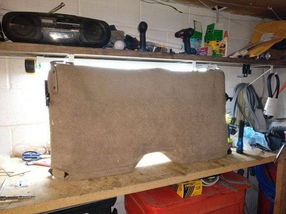 Here is a picture of the seat back with the cover and all hardware installed. Looks like new. If you notice there is a piece of the back sticking up about 2/3rds of the way from the left side. I took a utility knife to cut a slit where the carpet and the vinyl come together. This was to give an opening for the subwoofer wires and access to the various subwoofer controls. I then used hook and loop pieces to hold the slit opening together.