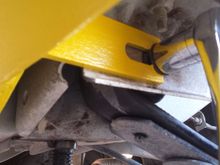 Slide the fork over the bolt post and under the head
