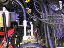 Coil bracket mounts around the coolant reservoir.