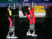 Napa's Part Number = 728216. Cost = $24.95 Ea. 

They come with red and black wire like the one on the left side of this photo. I used red and black electrical tape to make all the wires coming out the same color in an effort to make them Idiot proof if I need a jump start. I also wraped the splice with tape to help keep moisture out even more than the box does. Was thinking of filling the box with silicon caulk...