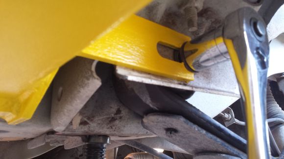 Slide the fork over the bolt post and under the head