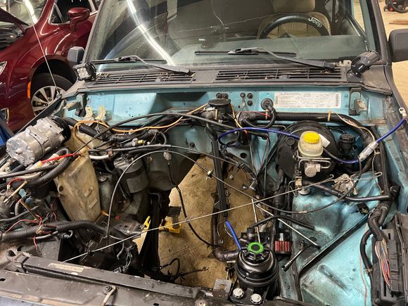 And this is the engine bay with no engine or trans. It’s still a rats nest, and I plan on pulling the entire engine harness and repairing it. 