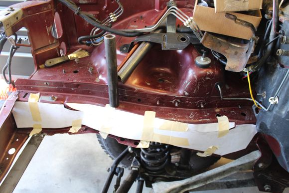 Cut out a cardboard template.
Thinking about tying in the roll cage into boxed frame by following the fender and spring support up at an angle, then turn it toward the firewall.