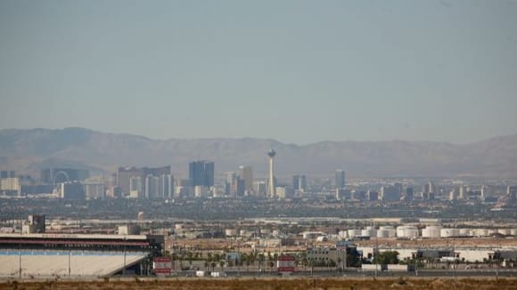 Vegas skyline with the grandstands of LVIR in the lower left.