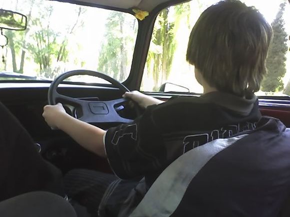 the boy driving the mini