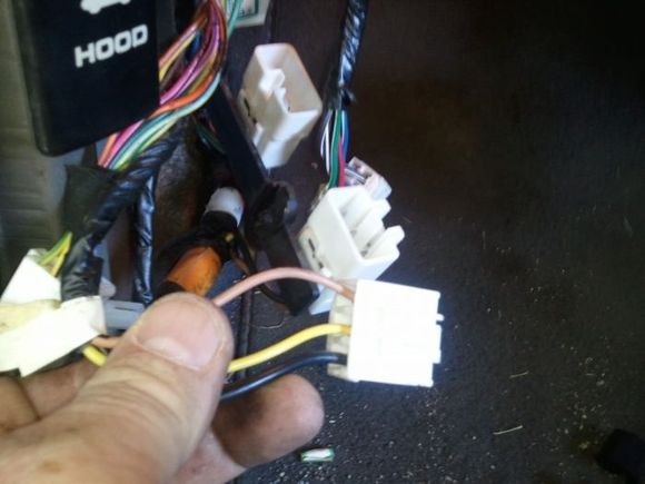 These are the two wires you need to find. They are behind the kick panel on the drivers side and in the middle of the three plugs.