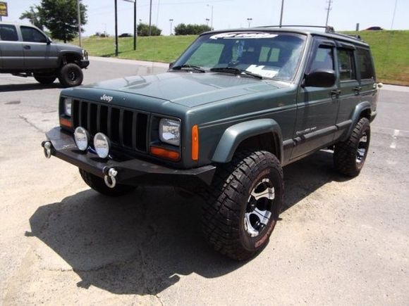 My Jeep after I got my rims put on, it's in the 4 Wheel Parts parking lot