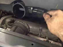 You can just see the upper clamp on the throttle body elbow
