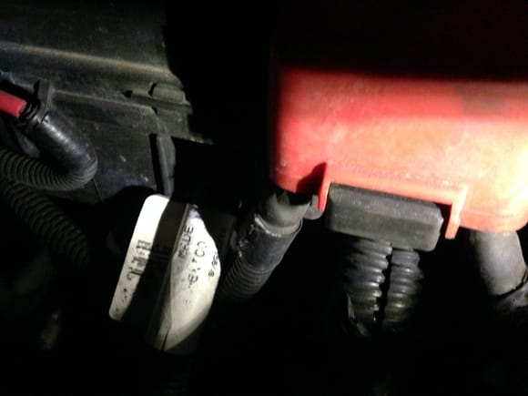 The red wire on the left is the electric power steering wire, the ones under the red cover are from the battery, then down to the starter.