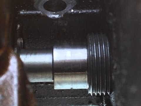 A replacement bolt threads into the head plug hole.