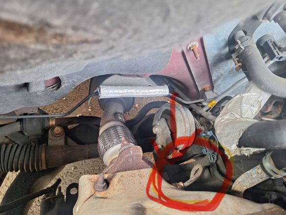 Right here under the heat shield, you have to remove the heat shield 