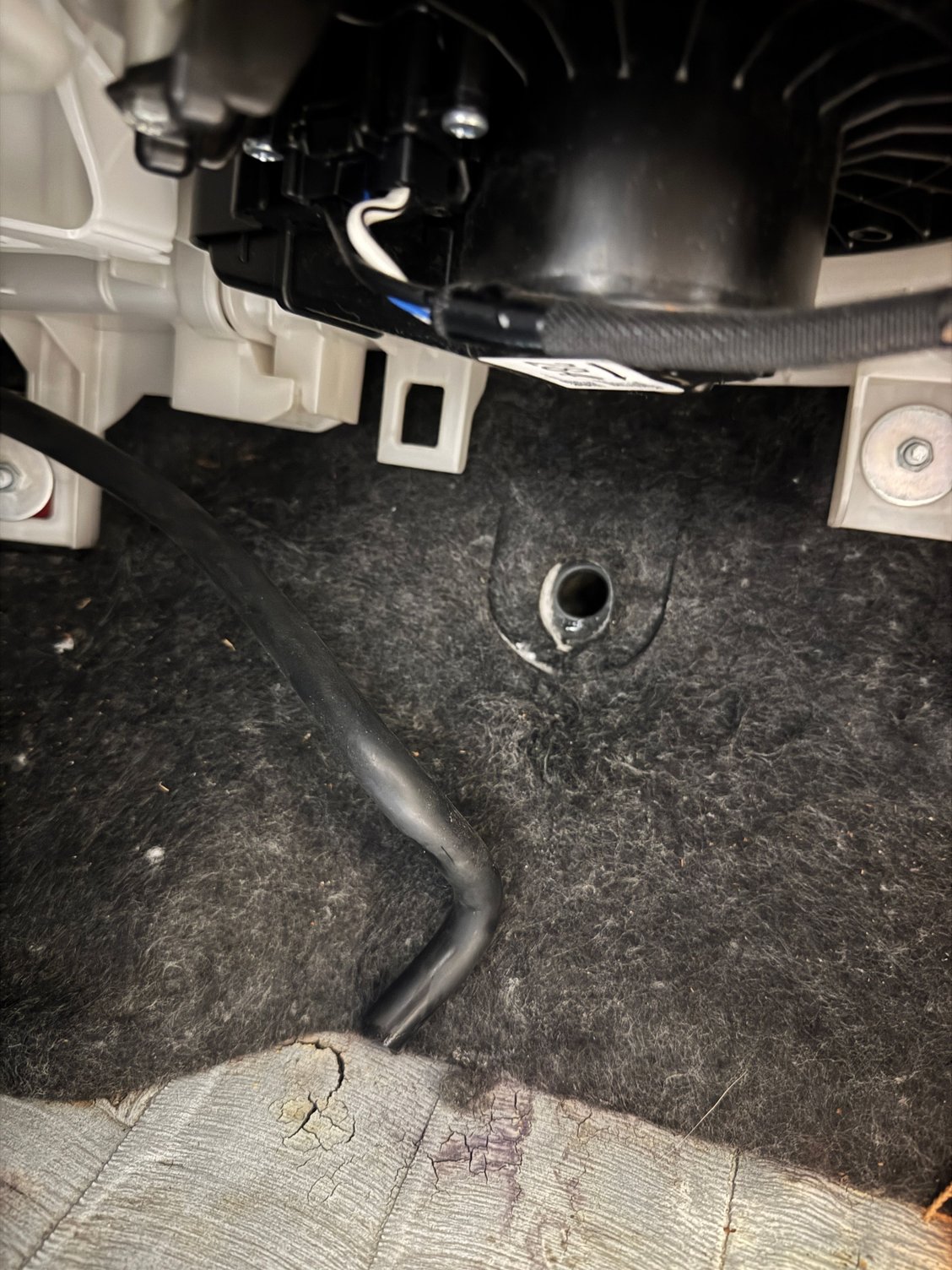 I removed AC hose to show there isn�t really a seal in here. It just fits loosely in the hole. Trail of water stains under felt, hard to photo. 