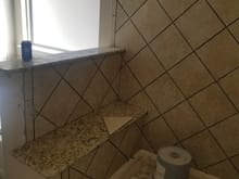 Travertine in baths and shower surrounds, as well as bathroom floors upstairs and in master bath.