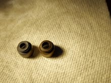 Valve stem seals.  New on left.  Old on right.  The new one is much more pliable.  There is also a considerable difference in diameter.  I'm trying not to get excited but the old one does seem to be in poor shape.